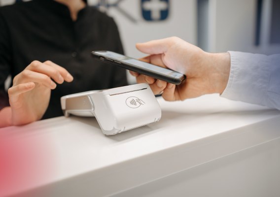 Customer paying by phone on a card terminal